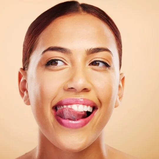 A happy female customer of Revived Image Spa showing her happiness after getting satisfying lip flip services.