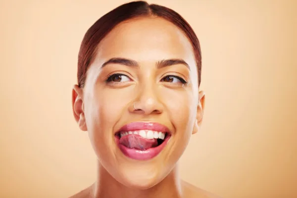 A happy female customer of Revived Image Spa showing her happiness after getting satisfying lip flip services.