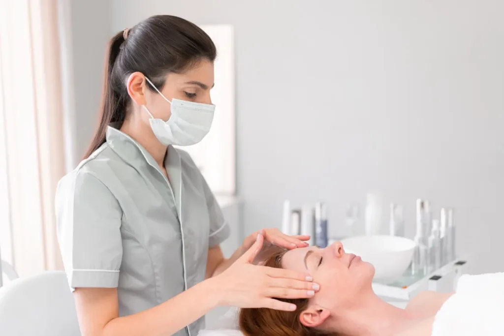 Licensed esthetician performing a facial treatment on a client at a professional medical spa in Novi MI.