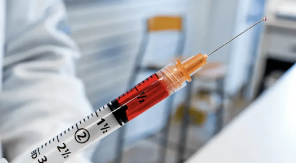 Close-up of a syringe filled with vitamin B12 injections, ready for administration at a wellness clinic in Novi, Michigan.