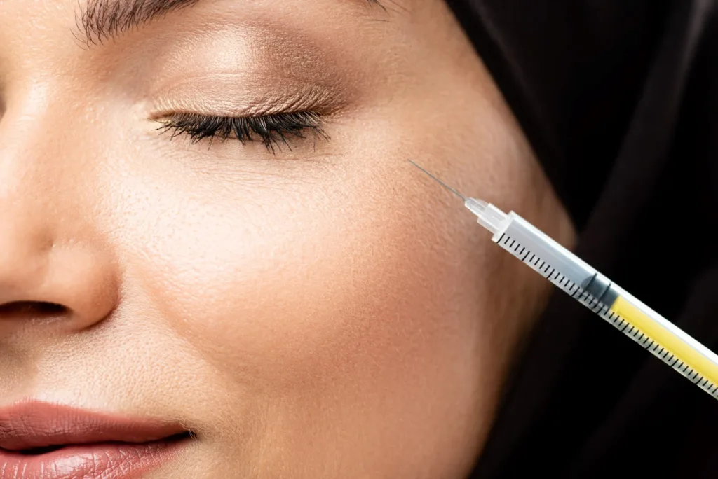 A close-up of a woman receiving a gentle cosmetic treatment near the eye area, illustrating the type of results people often look for when searching for anti wrinkle injections near me.