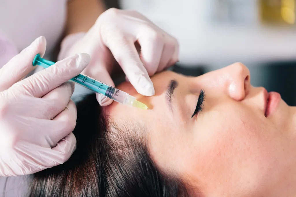 A licensed aesthetic professional administering a precise facial injection to highlight the natural botox benefits, including smoother skin and reduced fine lines, in a clean clinical setting.