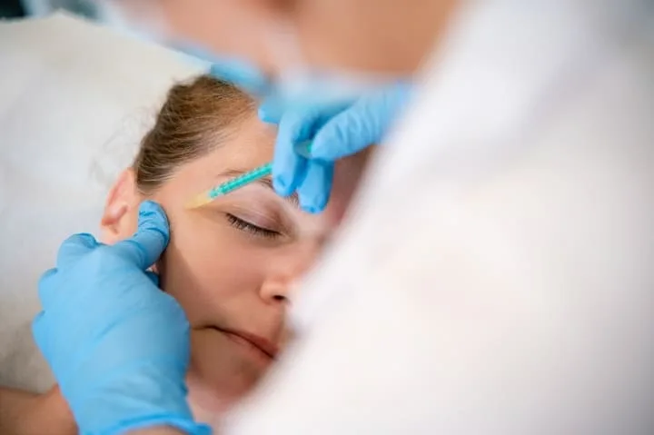 A woman receiving facial injection during professional aesthetic treatments in Novi.