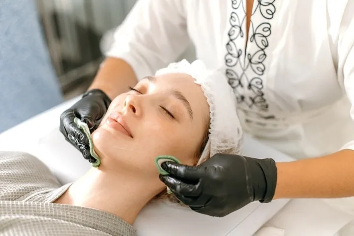 A woman receiving professional skin tightening treatments at a spa